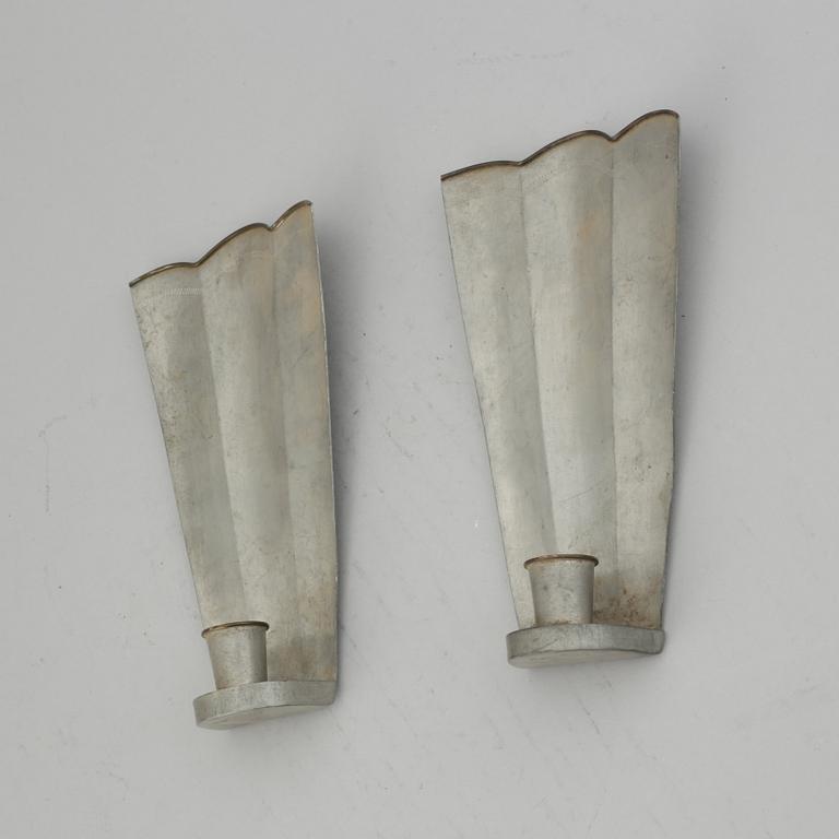 Firma Svenskt Tenn, a pair of pewter and brass wall sconces, Sweden 1925.