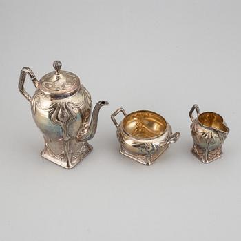 An art nouveau silver coffee pot, sugar bowl and creamer, mark of CF Källström, Malmö 1901.