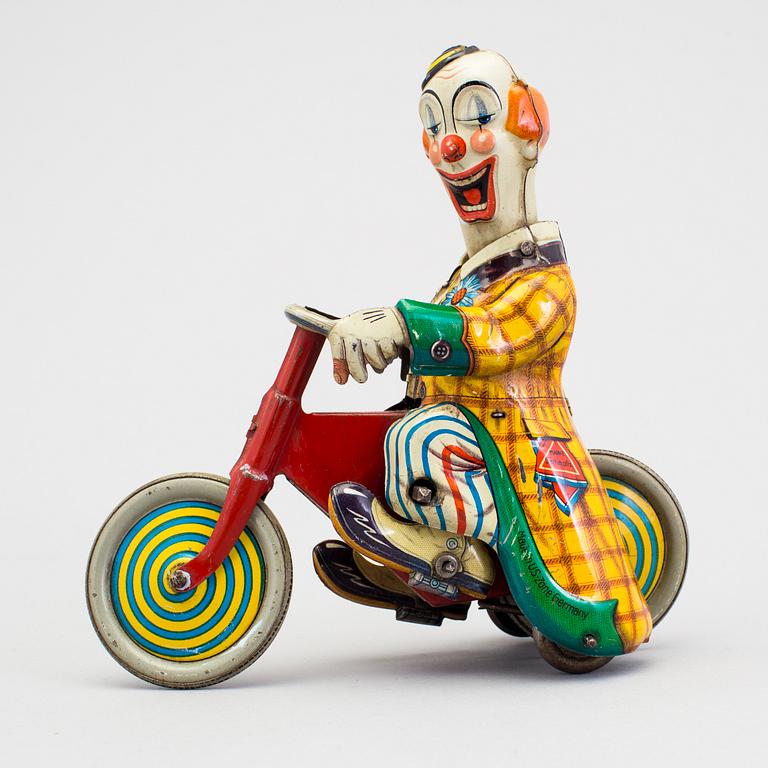 A tinplate Technofix bicycling clown Germany c. 1950.