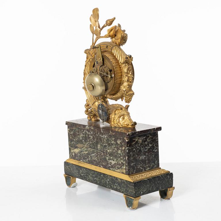 A presumably French Empire-style gilt bronze and marble mantel clock, later part 19th century.