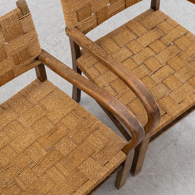 A pair of stained beech armchairs, first half of the 20th Century.