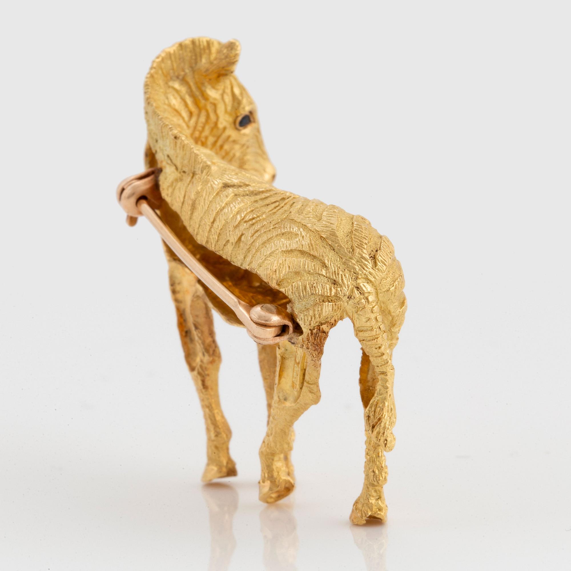 A Tiffany brooch in 18K gold set with sapphires designed as a zebra.
