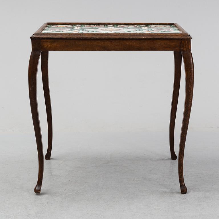 An oak table with glazed tiles by  Anna-Lisa Thomson, S.t Erik, dated 1931.
