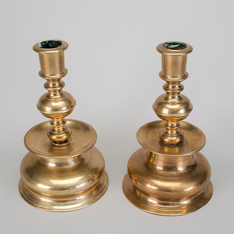 A set of two 18th century baroque brass candle sticks.