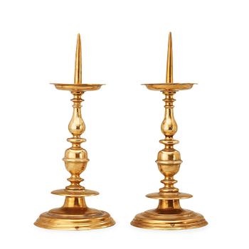 A pair of Baroque 17th century brass pricket candlesticks.