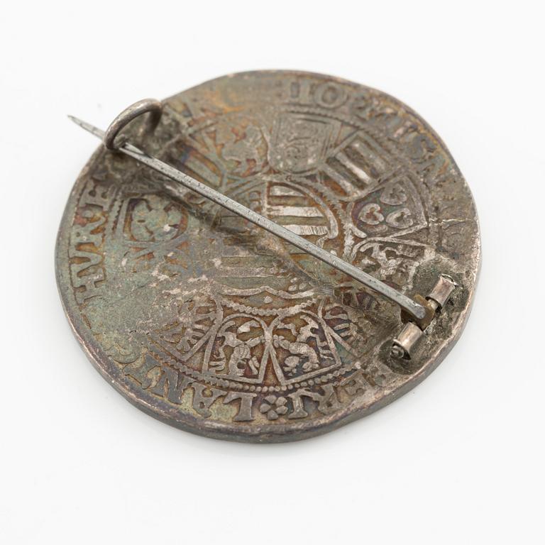 Two bracelets, a brooch, and a pendant with coins.