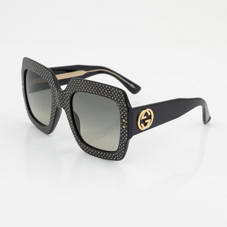 Gucci, a pair of black plastic and rhinestone sunglasses.