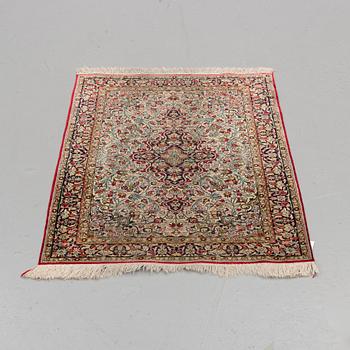 A silk Qum rug, around 114 x 80 cm.