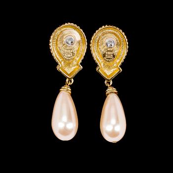 A pair of golden earclips by Givenchy.