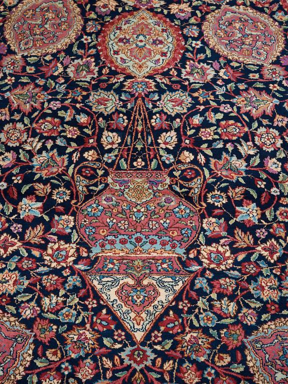 A CARPET. A semi-antique Kerman. 614,5 x 360,5 cm.