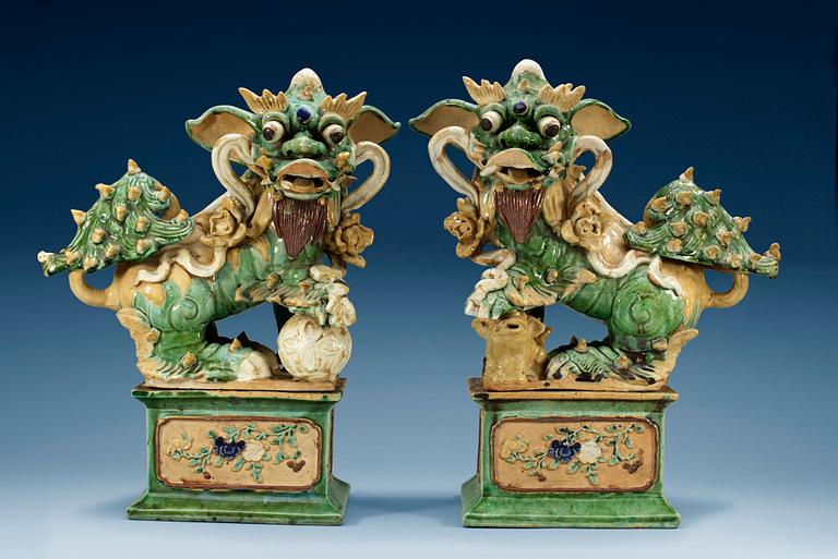 A pair of figures of Buddhist Lions on stands, Qing dynasty (1644-1912). (2).