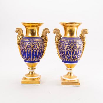 A pair of French Empire porcelain urns.