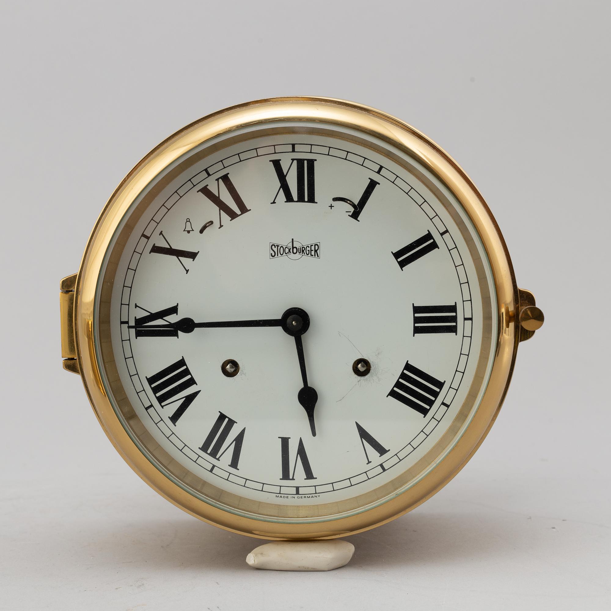 A BRASS MARINE CLOCK AND BAROMETER BY STOCKBURGER.