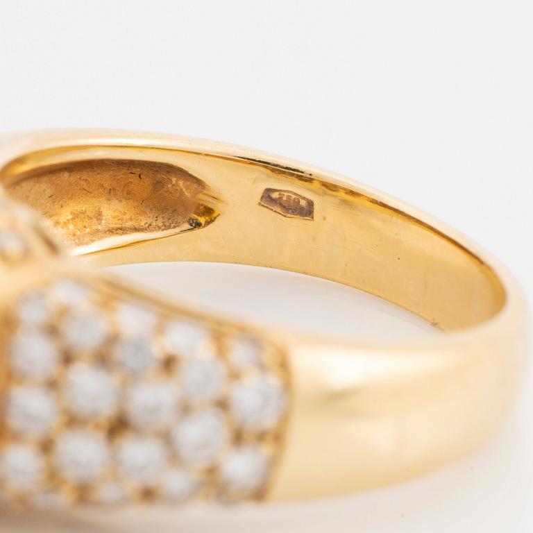 An 18K gold ring set with a cultured South Sea pearl and round brilliant-cut diamonds.