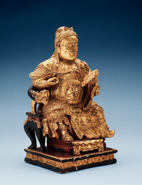A wooden, gilt and lacquered figure of an chinese general, Qing dynasty, presumably Qianlong (1736-95).