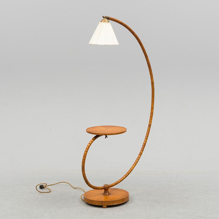 A first half of the 20th century floor lamp with table.