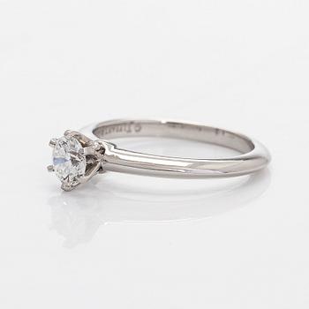 Tiffany & Co, a platinum solitaire ring with a brilliant-cut diamond.