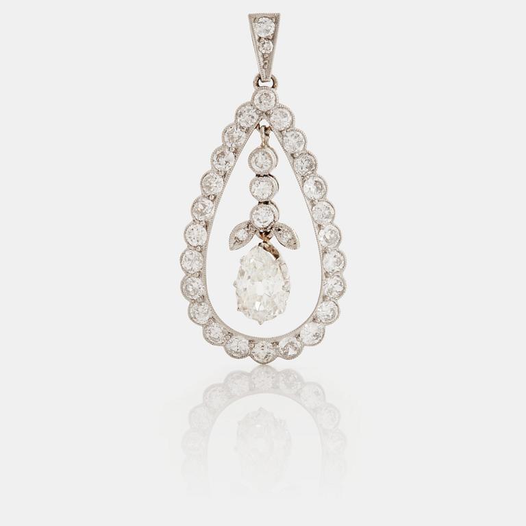 A pendant set with a pear cut diamond surrounded by old cut diamonds.