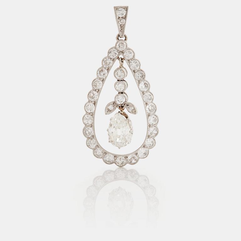 A pendant set with a pear cut diamond surrounded by old cut diamonds.