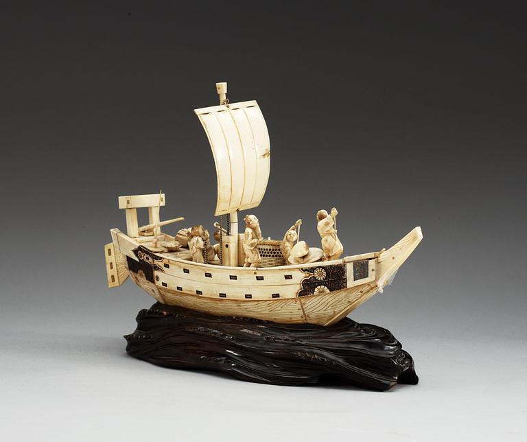 A Japanese ivory model of a ship with fishermen, Meiji period ca 1900.