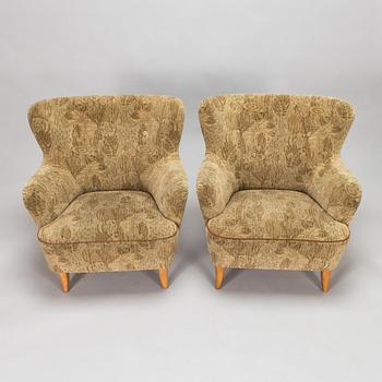 A pair of 1950s armchairs.