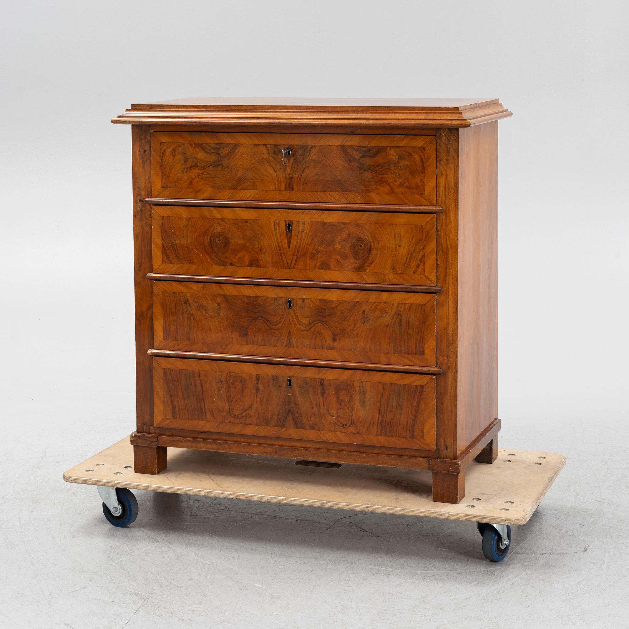 A walnut-veneered dresser, around 1900.