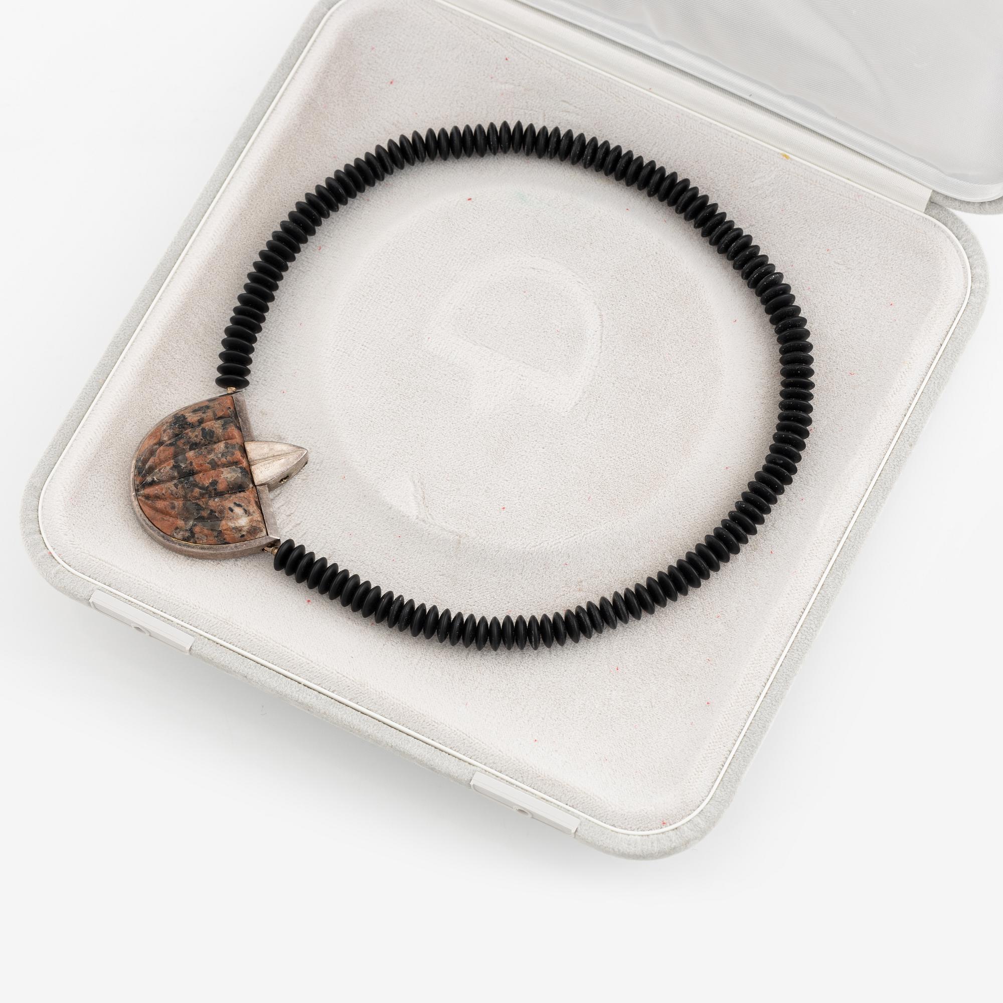 Gaudy necklace, silver and carved stone.