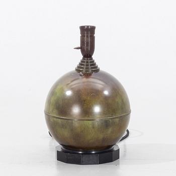 A patinated table lamp from the first half of the 20th century.