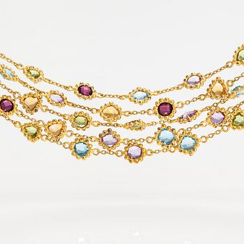 A gilded silver bracelet with topazes, garnets, peridotes, amethysts and quartzes.
