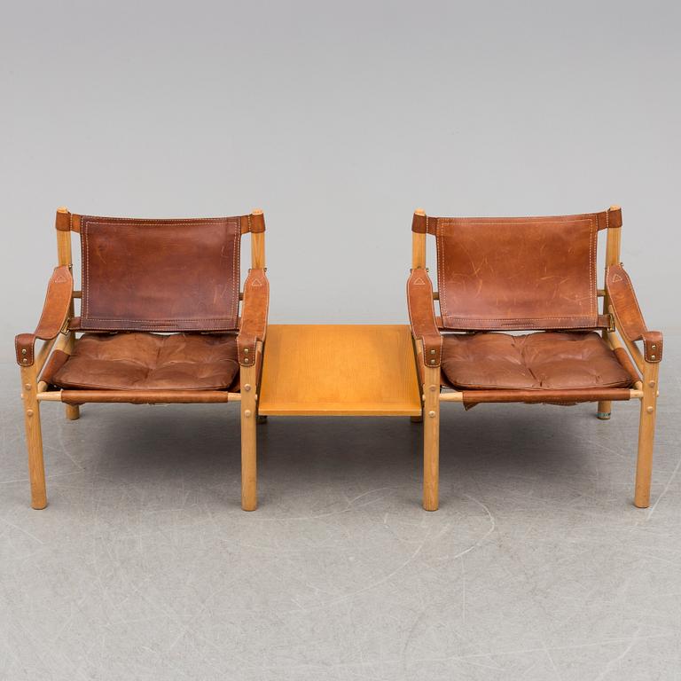 A pair of easy chairs by Arne Norell with a table leaf.