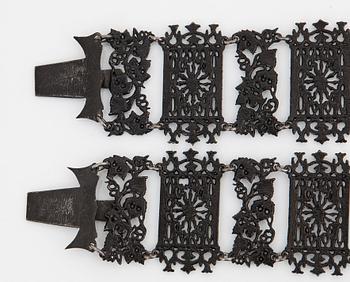 A Berlin steel and iron parure comprising a necklace, two bracelets and a brooch.