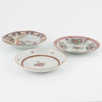 A group of seven Chinese porcelain plates and a charger, 18th / 19th Century.