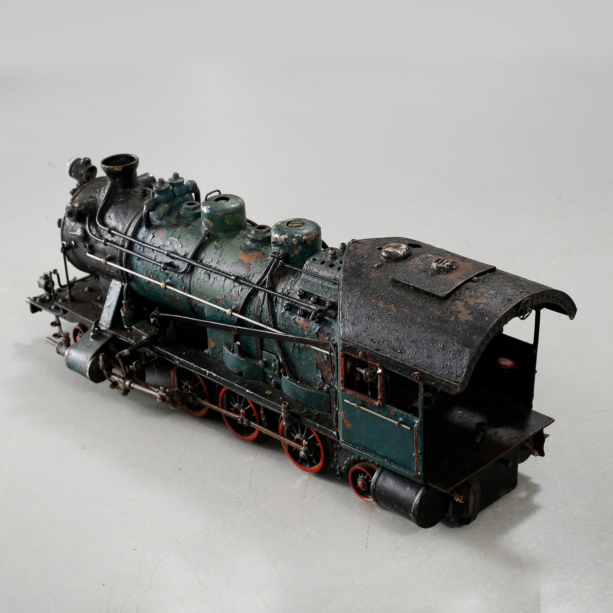 A steam engine with tender and a steam engine, probably England, first half of / mid 20th century.