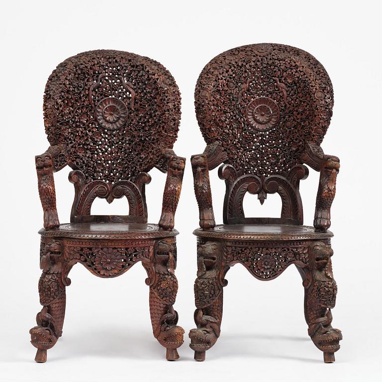 A pair of carved 'blackwood' armchairs, Bombay presidency, British Raj, circa 1880.