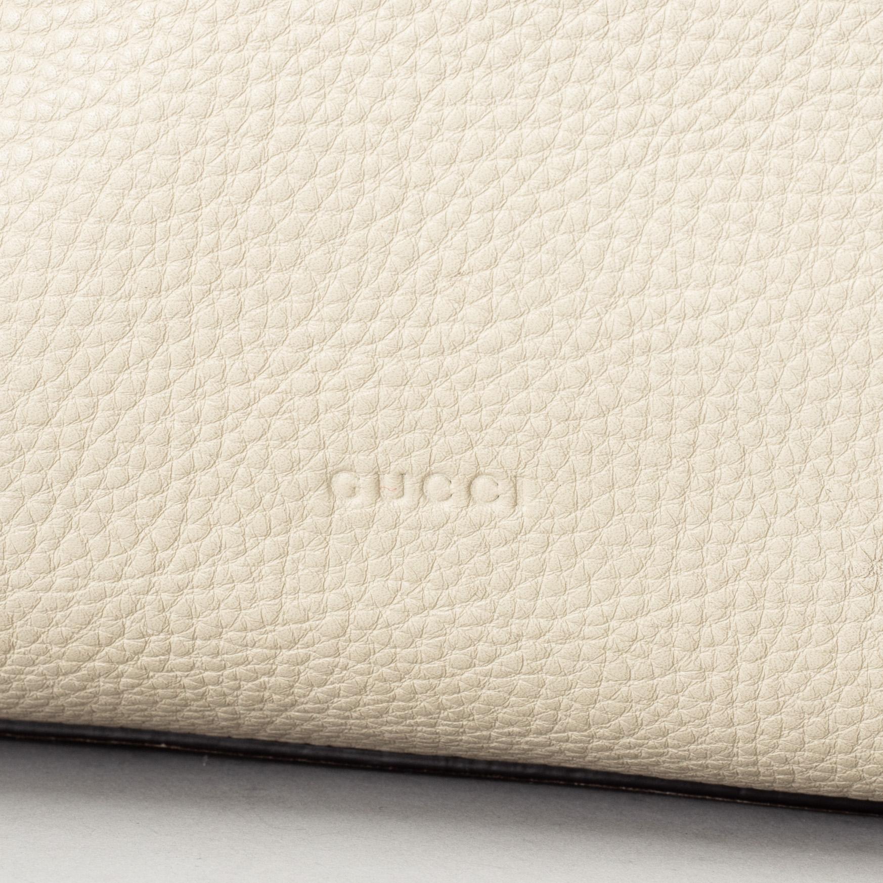 GUCCI, a white leather tote bag with bamboo handles.