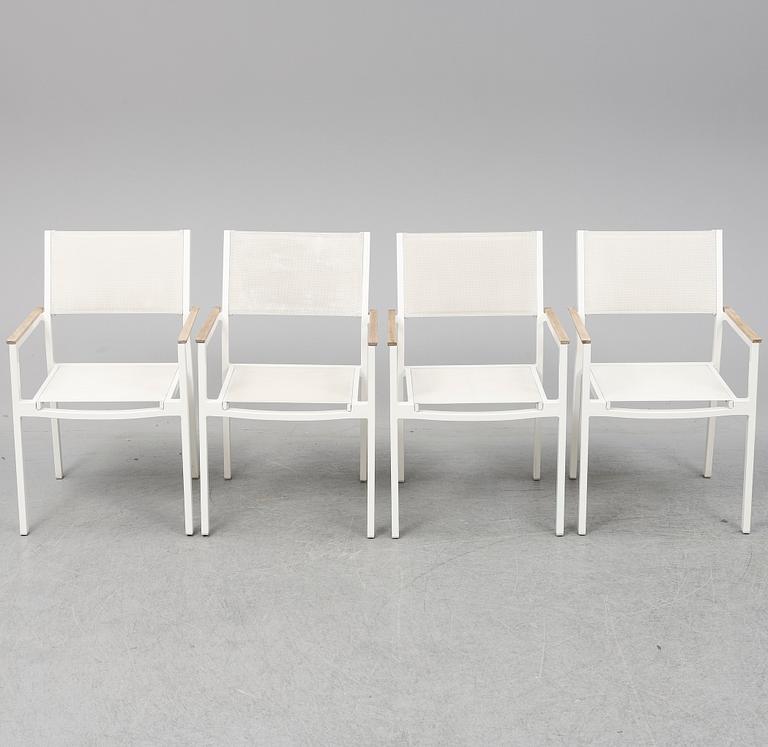 A garden table with four chairs, Gloster.