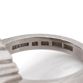 A ring set with an oval, mixed-cut sapphire and round, brilliant-cut diamonds.