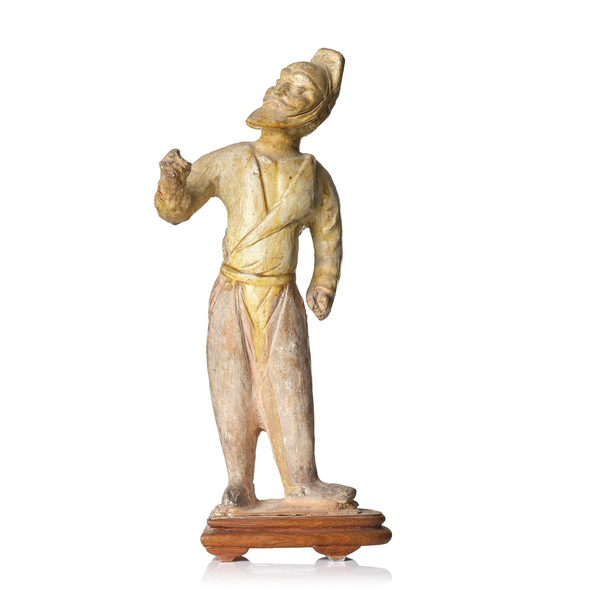 A yellow glazed potted figure of a groom, Tang dynasty (618-907).