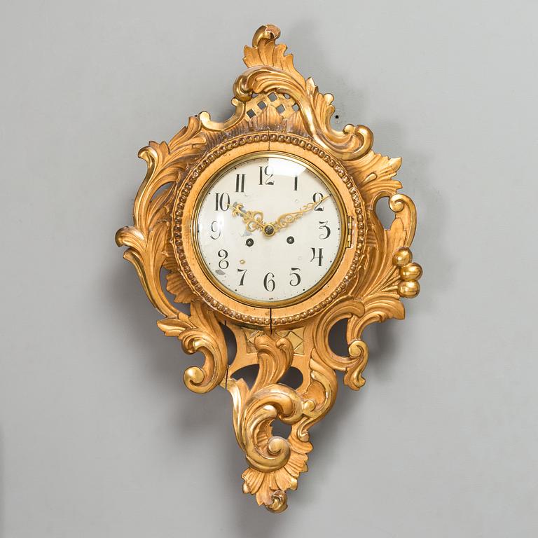 A Rococo style wall clock from first half of the 20th century.