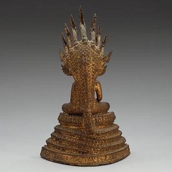 A gilt bronze figure of Buddha, enthroned on a seven headed coiled Naga, Thailand, 19th Century.