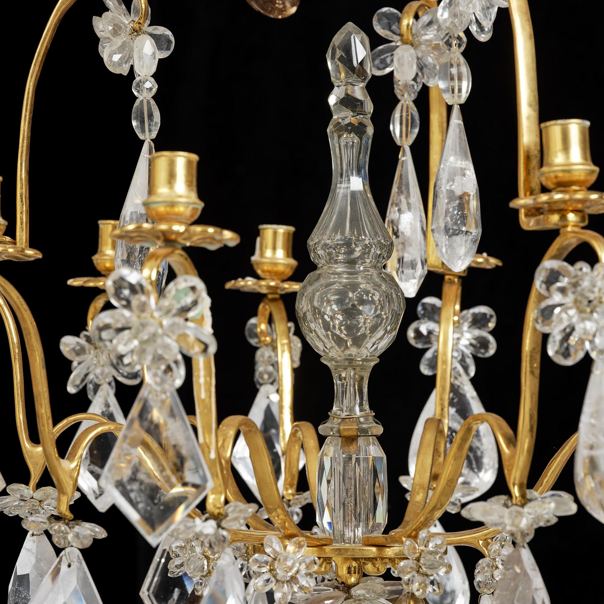 A near pair of Franch Louis-XV-style nine-branch gilt bronze and rock crystal chandeliers, later part 19th century.