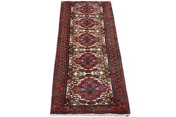 An oriental runner carpet, c. 295 x 95 cm.