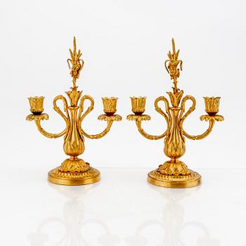 A pair of Louis XV-style bronze candelabras.
