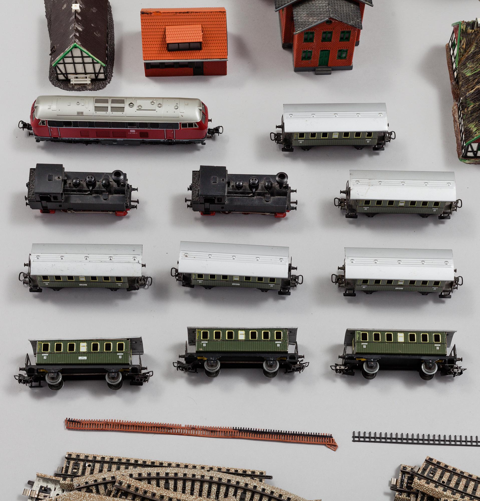A model train set with locomotives, wagons, rail H0, Danish village houses, tunnel, mountain and more.