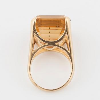 An emerald cut citrin ring.