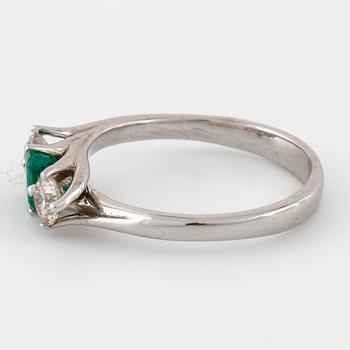 A emerald and brilliant cut diamond ring.