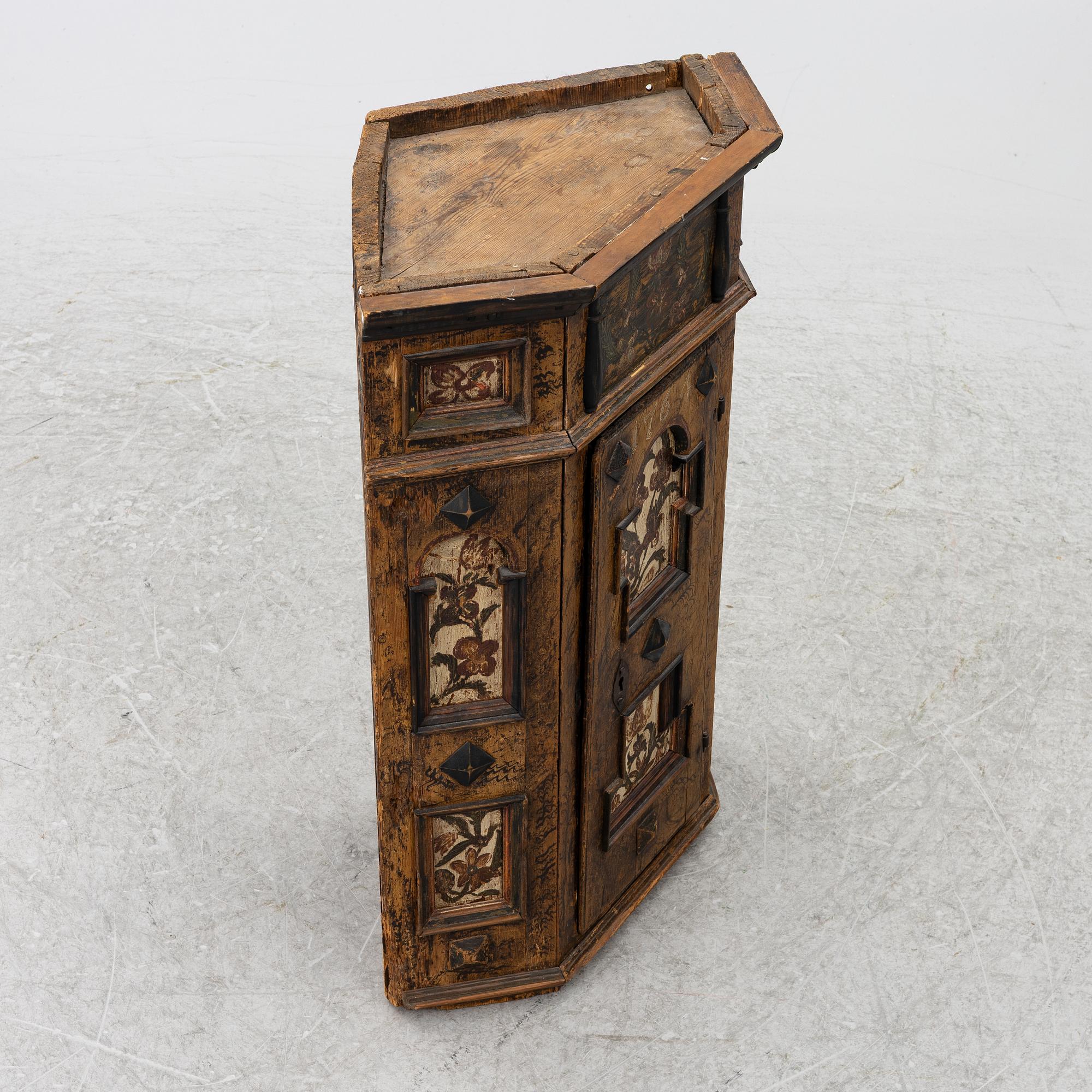 A corner cabinet, 18th Century.