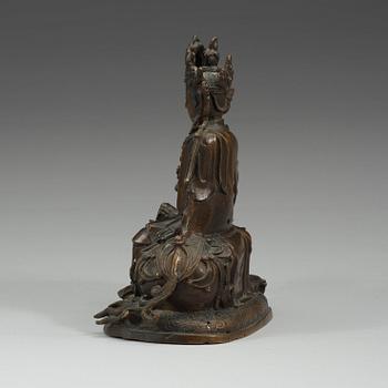 A bronze figure of Guanyin seated on a mythical beast, presumably Qing dynasty.