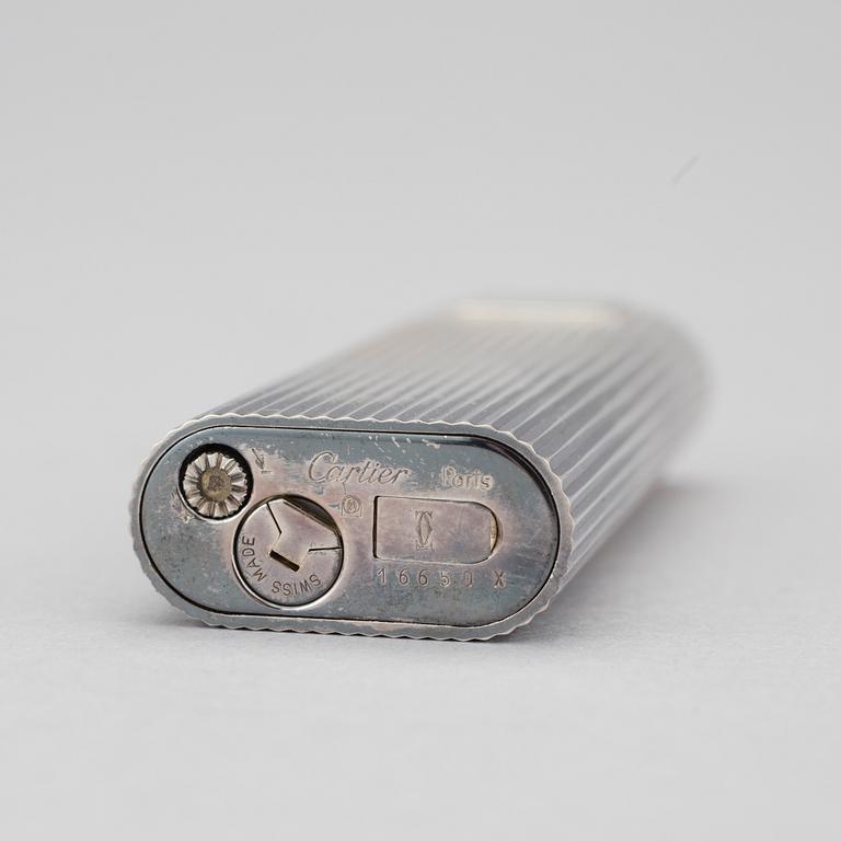 A must de Cartier silver plated cigarette lighter.