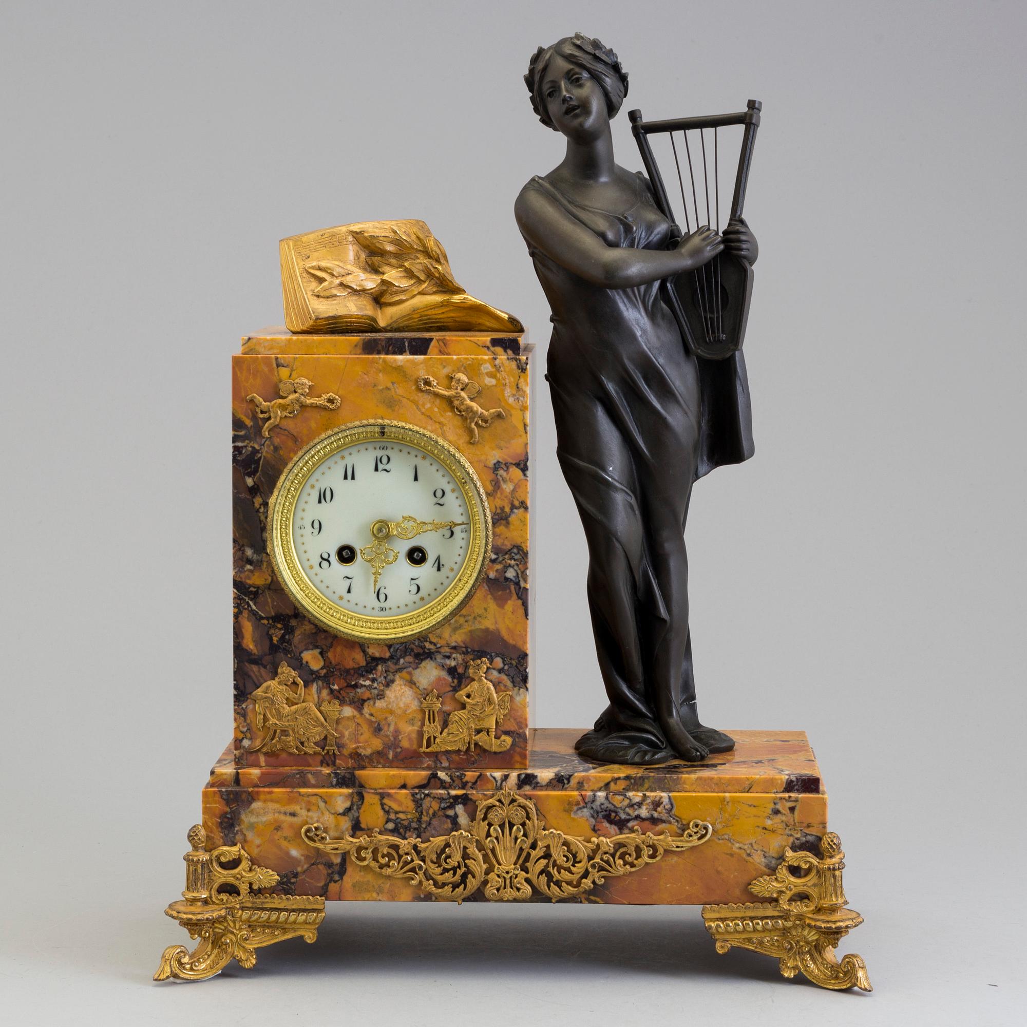A turn of the century 1900 gilt brass and marble century mantle clock.